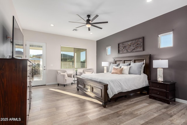 bedroom featuring baseboards, visible vents, and light wood finished floors