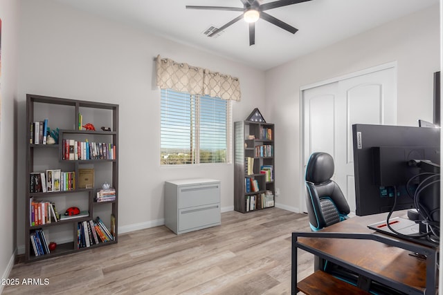 office area with visible vents, baseboards, a ceiling fan, and light wood-style floors