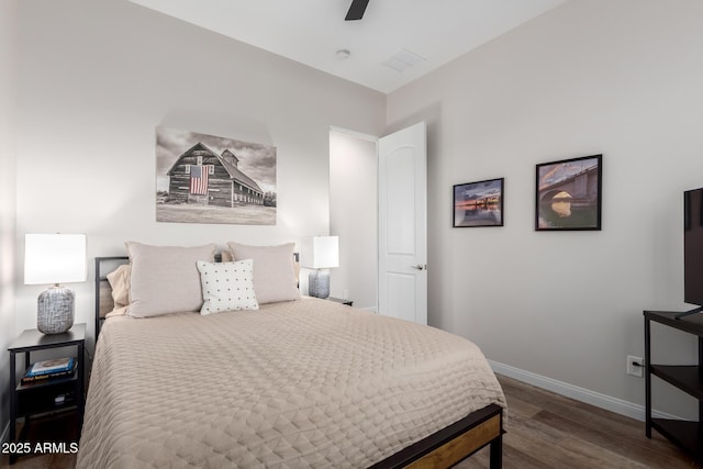 bedroom with wood finished floors, a ceiling fan, and baseboards