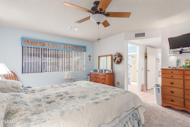 bedroom with light tile patterned floors, ceiling fan, visible vents, and a textured ceiling