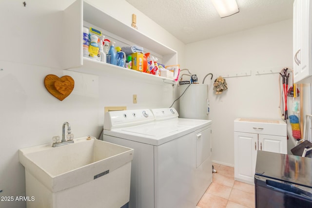 laundry room with cabinet space, independent washer and dryer, a textured ceiling, a sink, and light tile patterned flooring