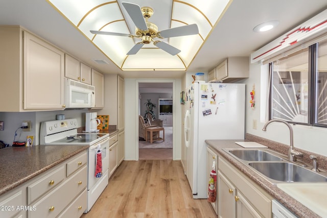 kitchen featuring white appliances, visible vents, a ceiling fan, light wood-type flooring, and a sink