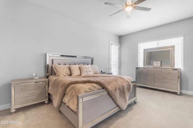 bedroom featuring ceiling fan, baseboards, and light colored carpet