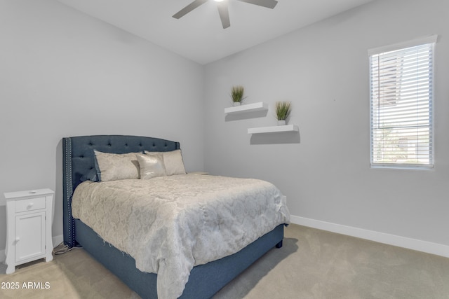 bedroom with light carpet, a ceiling fan, baseboards, and multiple windows