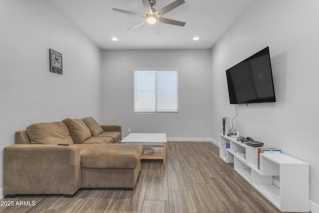 living area featuring recessed lighting, wood finished floors, baseboards, and ceiling fan