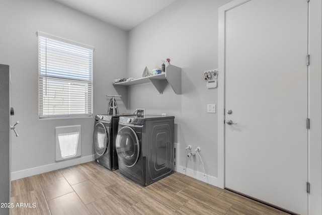 laundry room featuring independent washer and dryer, plenty of natural light, baseboards, and laundry area