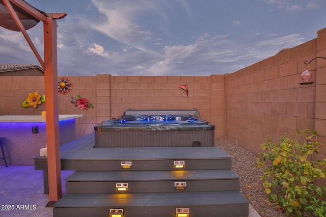 wooden deck with fence and hot tub deck surround