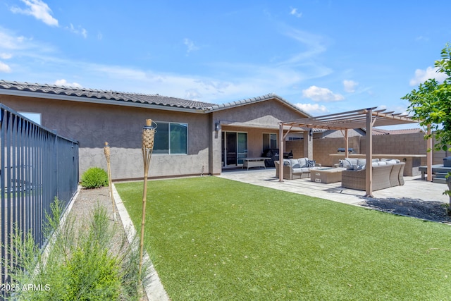 back of property featuring a pergola, fence, a yard, stucco siding, and an outdoor living space