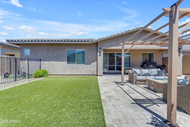 back of house featuring a patio area, fence, a yard, an outdoor living space with a fire pit, and stucco siding