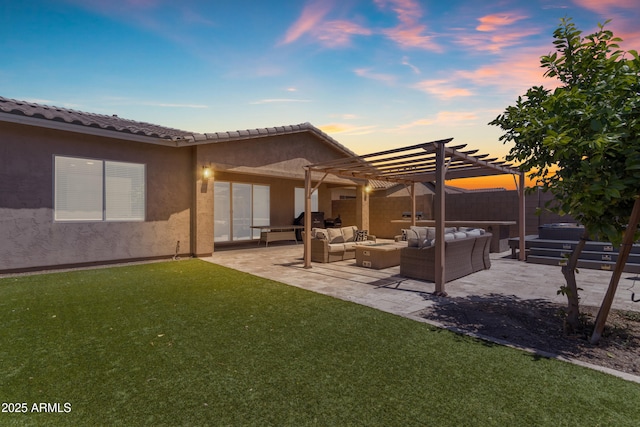 back of property at dusk with a pergola, an outdoor living space, a lawn, fence, and stucco siding