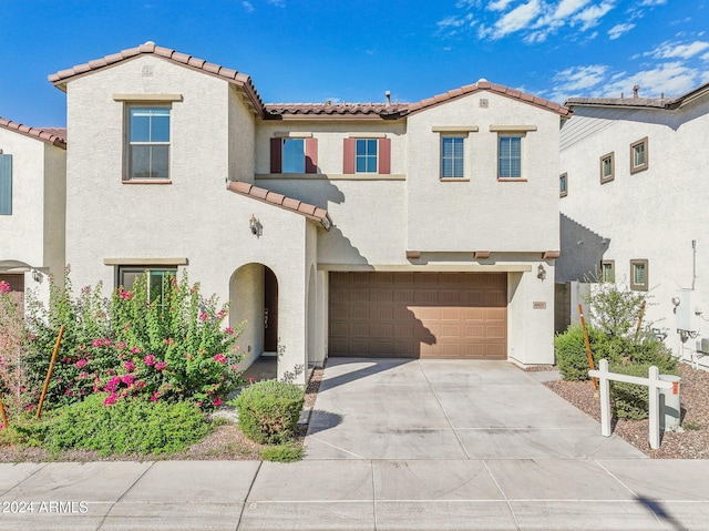 mediterranean / spanish-style house featuring a garage