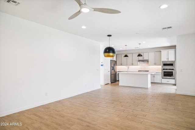 unfurnished living room with ceiling fan and light hardwood / wood-style flooring