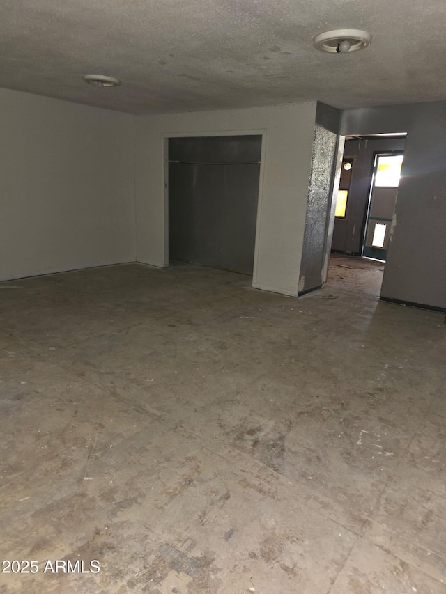 813 N Berry Ave, Winslow, AZ 86047 - unfurnished room with a textured ceiling