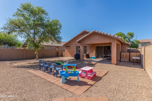 4817 W St Charles Ave, Laveen, AZ 85339 - rear view of house with stucco siding, a fenced backyard, and a patio area