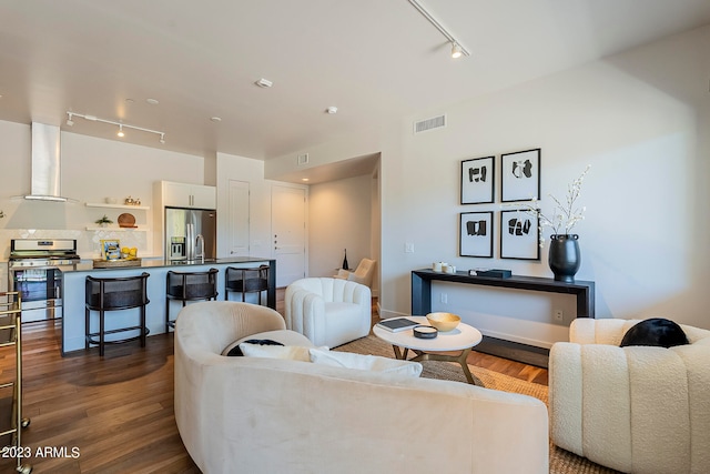 living room with track lighting and dark hardwood / wood-style flooring