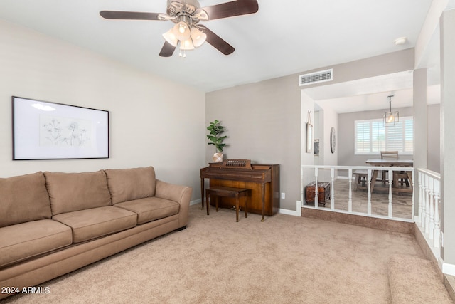 living room featuring light colored carpet and ceiling fan