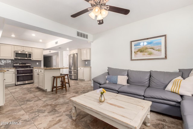 tiled living room with ceiling fan