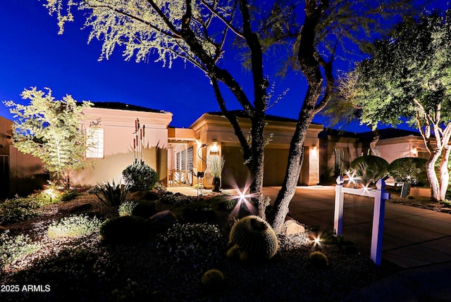 view of front of house featuring a garage and stucco siding
