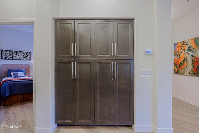 interior space featuring wood finished floors and baseboards