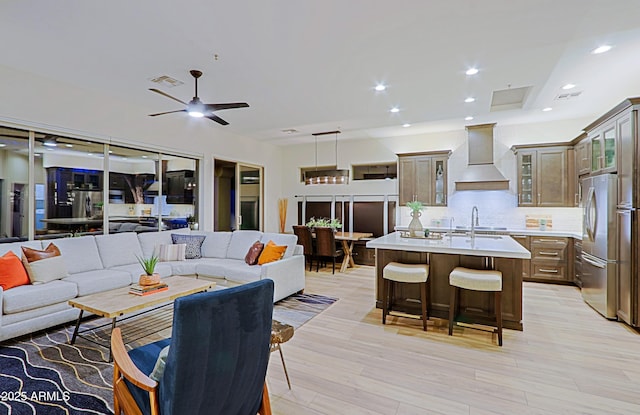 living room featuring visible vents, ceiling fan, light wood-type flooring, and recessed lighting