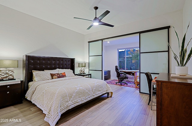 bedroom with light wood-style flooring and a ceiling fan