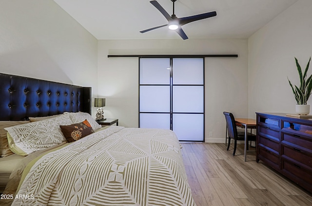 bedroom featuring baseboards, a ceiling fan, and wood finished floors