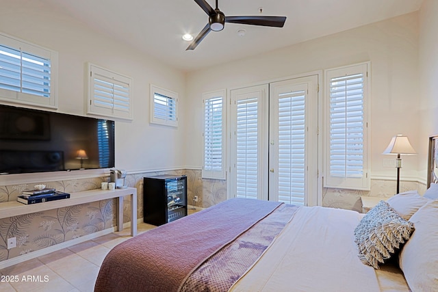 tiled bedroom with access to exterior and a ceiling fan