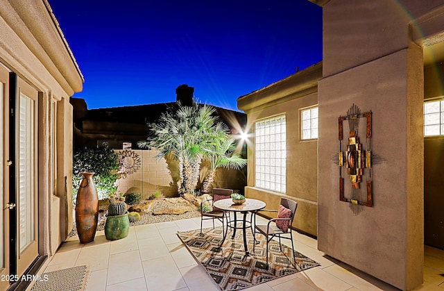 patio at night with outdoor dining area