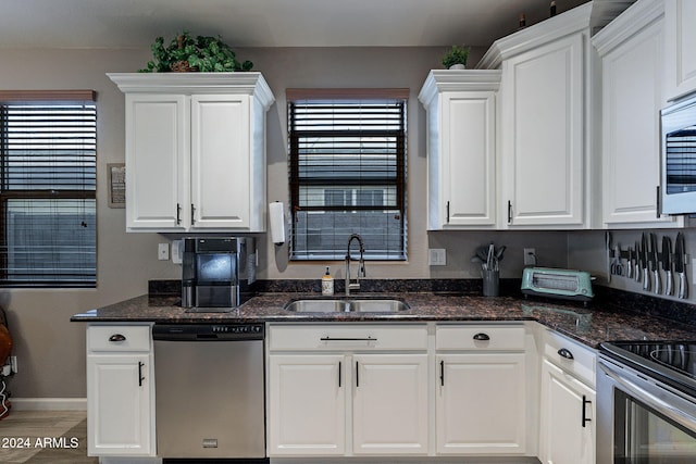 kitchen featuring a wealth of natural light, sink, white cabinets, and stainless steel appliances