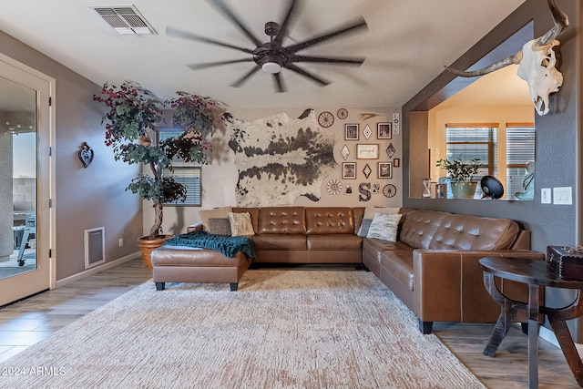 living room with ceiling fan and light hardwood / wood-style floors