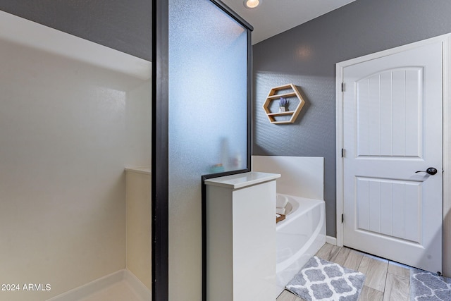 bathroom with wood-type flooring and independent shower and bath