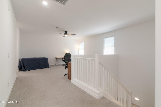 hallway with light colored carpet