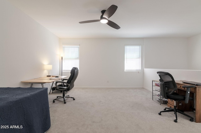 carpeted office space with a wealth of natural light and ceiling fan