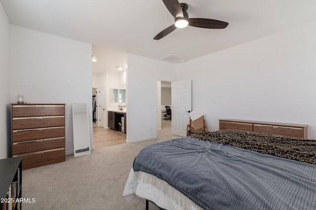 carpeted bedroom with ceiling fan and ensuite bathroom