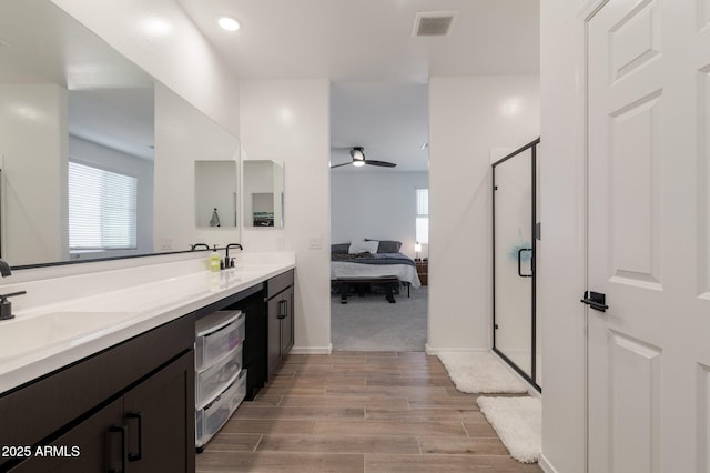 bathroom with vanity, ceiling fan, and walk in shower