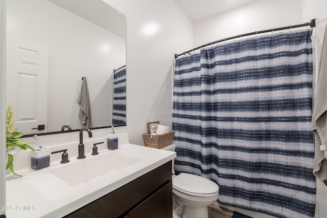 bathroom featuring vanity, a shower with curtain, and toilet