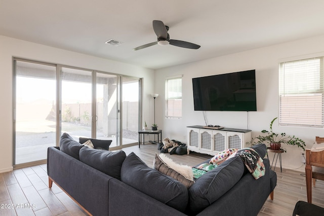 living room featuring ceiling fan and light hardwood / wood-style floors