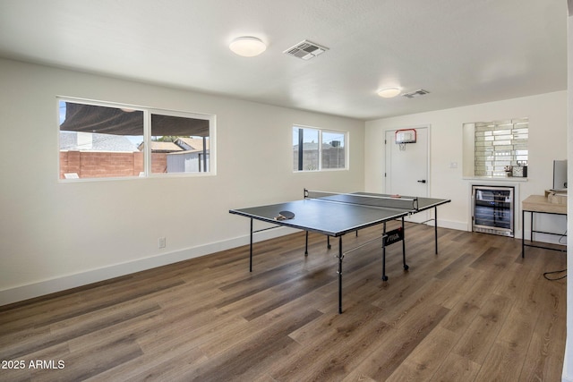 8022 E Columbus Ave, Scottsdale, AZ 85251 - recreation room with wine cooler, healthy amount of natural light, and wood finished floors