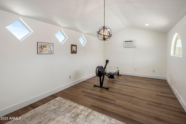 8022 E Columbus Ave, Scottsdale, AZ 85251 - workout area featuring a wall mounted air conditioner, a skylight, lofted ceiling, wood finished floors, and a chandelier