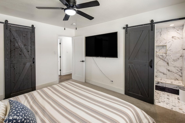 8022 E Columbus Ave, Scottsdale, AZ 85251 - carpeted bedroom featuring a barn door, connected bathroom, and ceiling fan