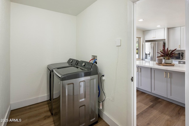 8022 E Columbus Ave, Scottsdale, AZ 85251 - laundry room with wood finished floors, independent washer and dryer, and recessed lighting