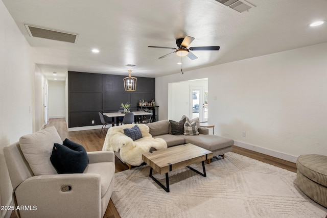 8022 E Columbus Ave, Scottsdale, AZ 85251 - living room featuring light wood finished floors, ceiling fan, recessed lighting, and a chandelier