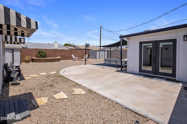 8022 E Columbus Ave, Scottsdale, AZ 85251 - fenced backyard with french doors, a patio area, and a storage shed