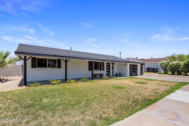 8022 E Columbus Ave, Scottsdale, AZ 85251 - ranch-style home with concrete driveway, an attached garage, a front lawn, stucco siding, and a shingled roof