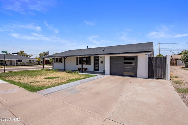 8022 E Columbus Ave, Scottsdale, AZ 85251 - view of front of house featuring a garage, stucco siding, driveway, and a front yard