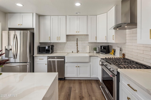 8022 E Columbus Ave, Scottsdale, AZ 85251 - kitchen featuring stainless steel appliances, wall chimney exhaust hood, white cabinets, and recessed lighting