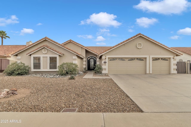 ranch-style home with a tiled roof, stucco siding, a chimney, driveway, and an attached garage