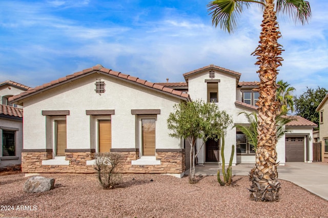 mediterranean / spanish-style house with a garage