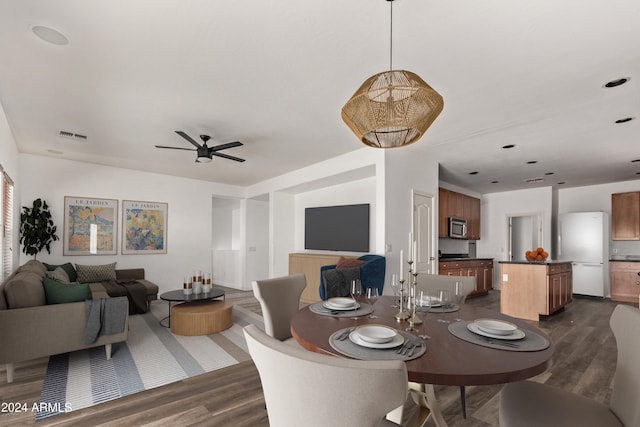 dining space with ceiling fan and dark hardwood / wood-style flooring