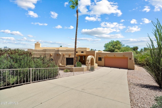 16927 E Trojan Ct, Fountain Hills, AZ 85268 - pueblo-style house with stucco siding, driveway, and a garage